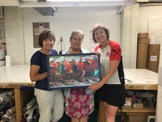 Members giving a poster of the Club to Annapolis Custom Yacht Canvas as a token of our appreciation