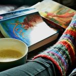 Reading 2 books with cozy socks and coffee
