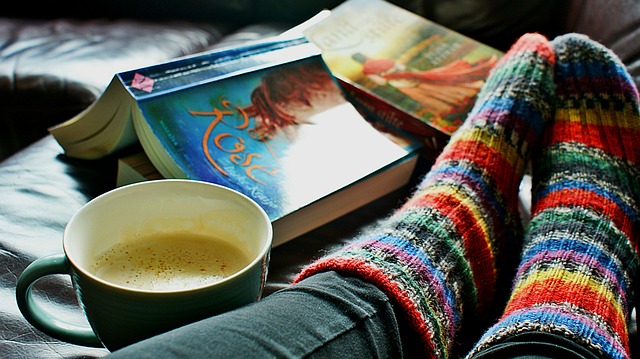 Reading 2 books with cozy socks and coffee