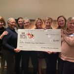 Club members receiving a check for $10,000 from 100 Women Who Care Annapolis