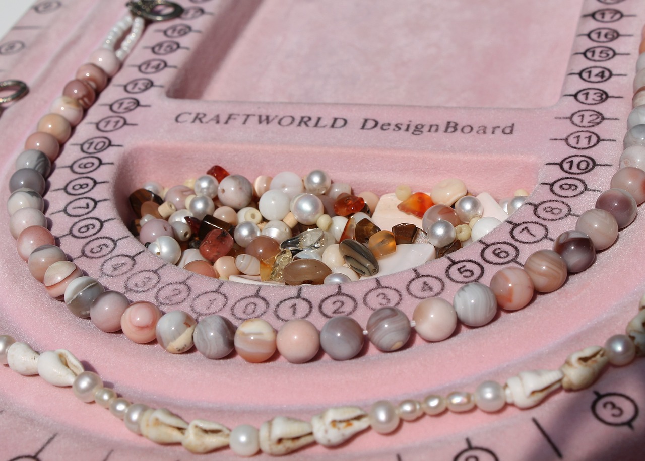 Pink craft beads on a bead board
