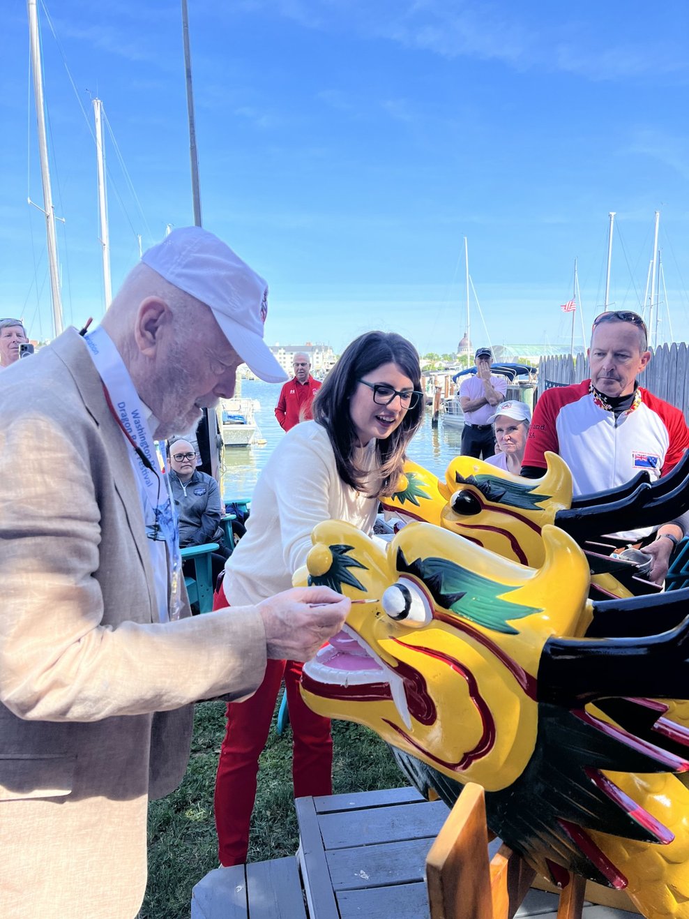 Founder Mike Ashford and Senator Sarah Elfreth paint the dragons' eyes at the Awaken the Dragon Ceremony in May 2023