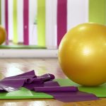 Photo of a pilates studio with a ball, mat, and other equipment