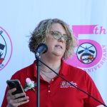 Jennifer A. Schneider, MS, RN, Director of the Bureau of Disease Prevention and Management at the Anne Arundel County Department of Health, sharing remarks about breast cancer and the benefits of dragon boating.